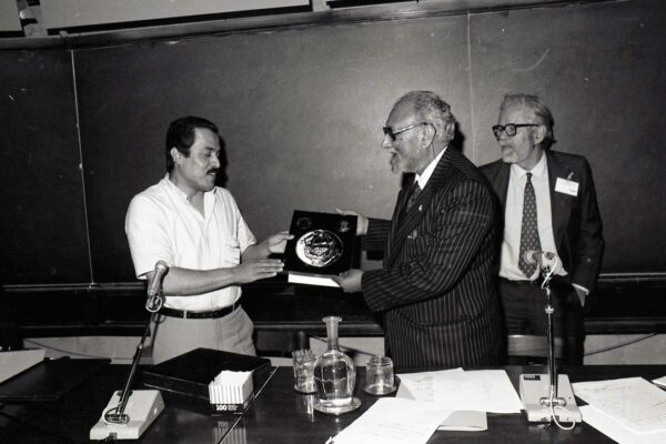 First symposium on physical and mathematical sciences in the Arab world, 1985 A scientist giving a plaque to Abdus Salam