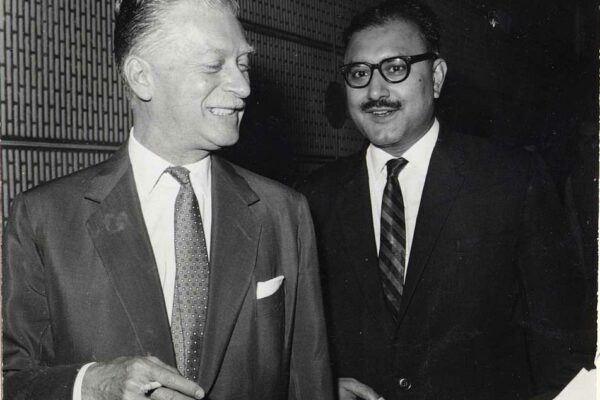Prince Raimondo della Torre e Tasso attends the ICTP inauguration ceremony, 1964 Prince Raimondo della Torre e Tasso and Abdus Salam standing together. They are smiling.